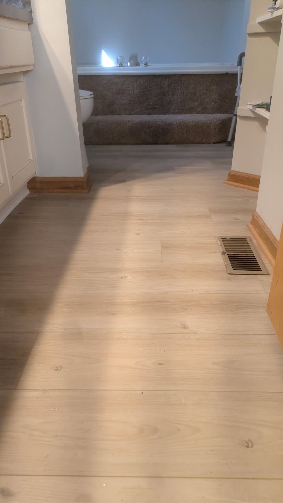 Bathroom Upgrade with Light Wood Flooring and Modern Fixtures image