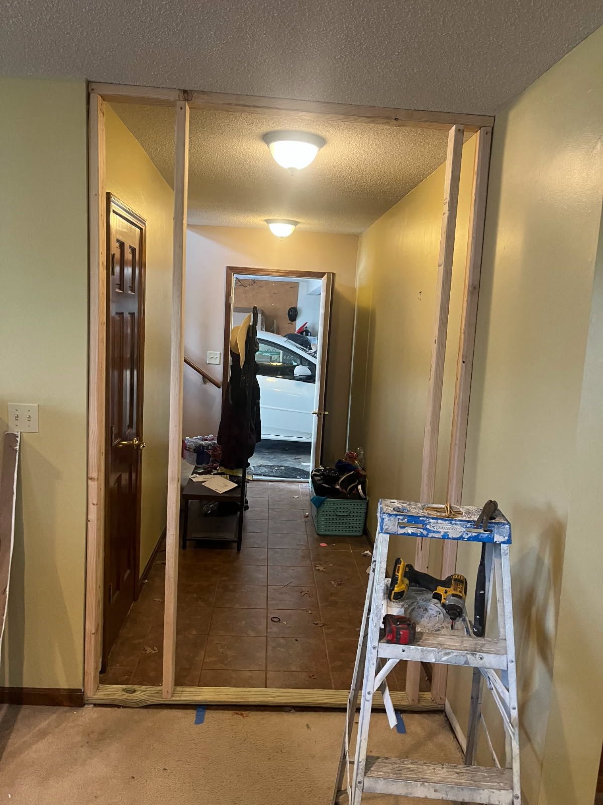 Expertly Framed Wall with Stained Door image Expertly Framed Wall with Stained Door image